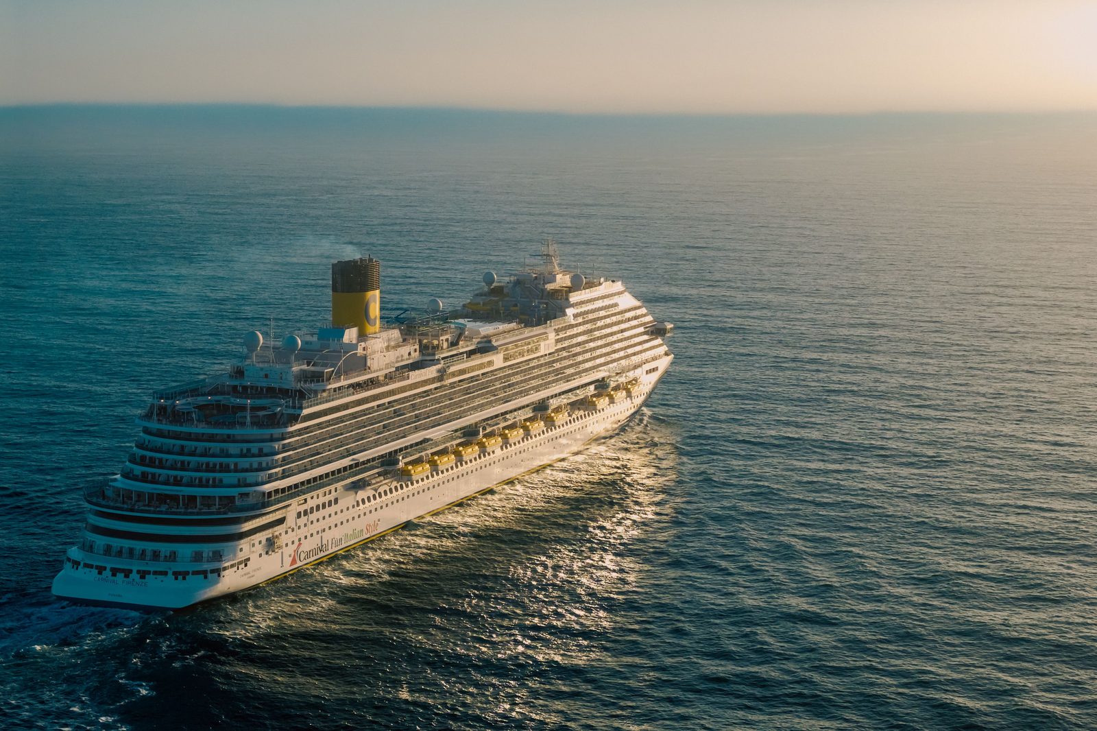 Cruise ship sailing at sunset